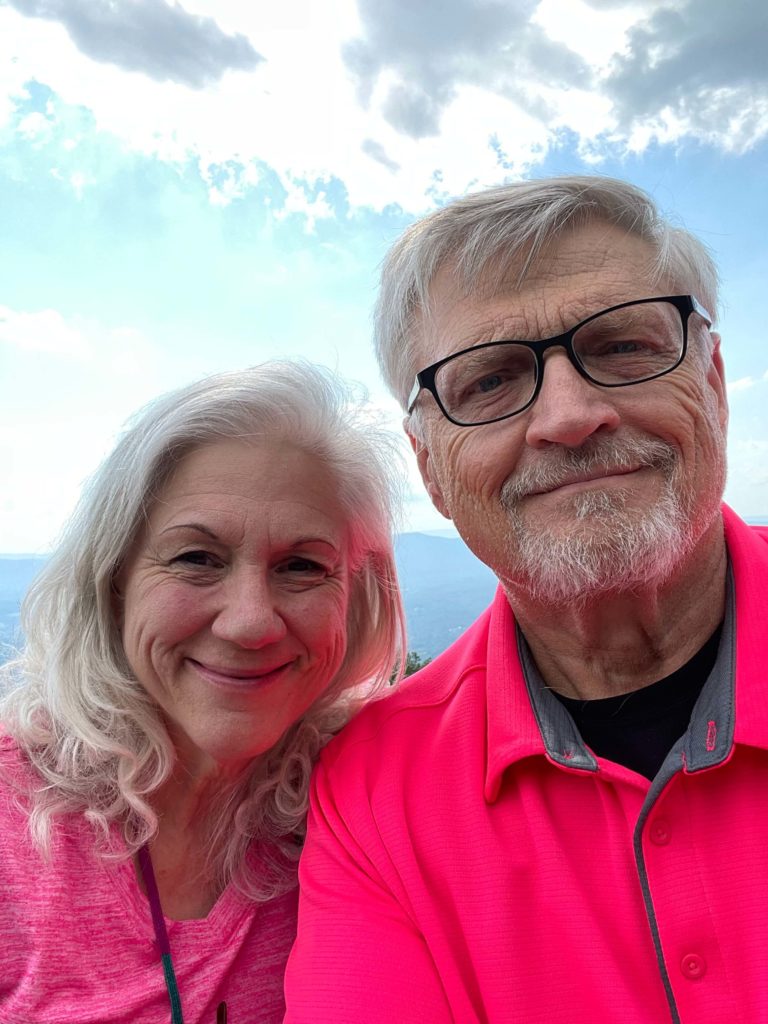 Rory and Linda in pink shirts in mountains